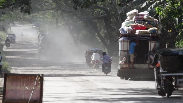 3rd World Road in a remote part of the Philippines, Trucks carrying way too much. 