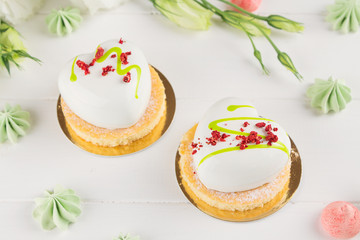 White heart shaped mousse cakes with white glaze