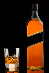 Whiskey in glass and bottle