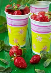 Ripe sweet strawberry and mint leaves.