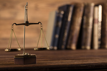 Golden scales of justice, gavel and books on brown background
Law code, gavel and books