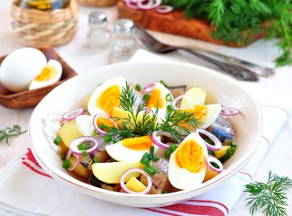 Salad of herring, boiled potatoes, eggs and onions with olive oil.