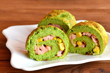 Omelet with spinach. Green scrambled eggs. Omelet stuffed with cheese, sausage and corn. Healthy meals slow. Simple eggs recipe