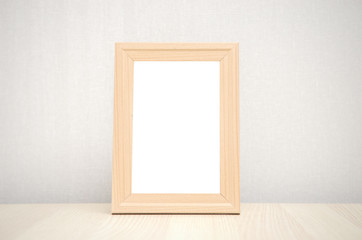 blank wood picture frame on the wall and the table wood