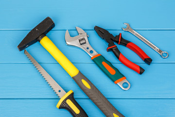 Work tools laying on blue wooden background