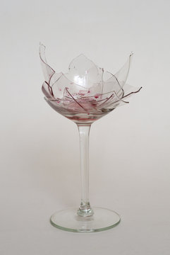Broken wine glass, dirty with red wine