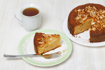 Piece of pie with pears, peanuts and cookies-sticks