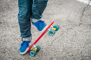 Stylish young guy on a red skateboard