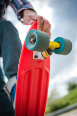 Stylish young guy on a red skateboard © ces