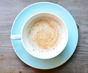 Cappuccino on wooden background