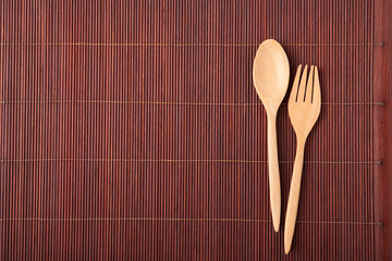 spoon wood kitchenware on bamboo mat background.