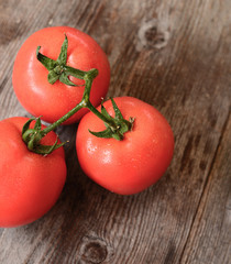 Fresh tomato on wooden background