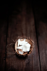 Coconut  pieces / close up of a coconut on a wooden background w