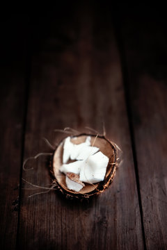 Coconut  pieces / close up of a coconut on a wooden background w