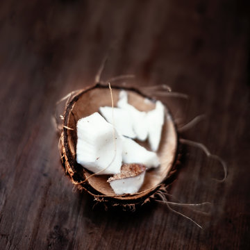 Coconut  pieces / close up of a coconut on a wooden background w