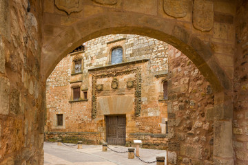 Gate to the town and facade of Contreras palace in Ayllon, Castile and Leon, Spain