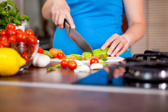 Pregnant Woman Chopping Up Fresh Vegetables