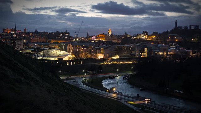 Edinburgh winter sunset time-lapse. A view from Salisbury crags of Scottish parliament, Calton hill, Edinburgh castle, north bridge and Royal mile.