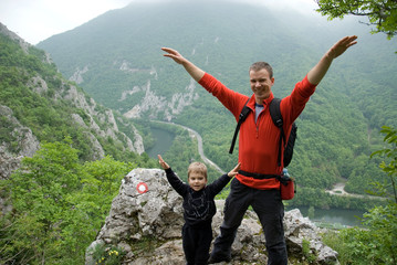 Dad and son enjoying the view from the mountain top