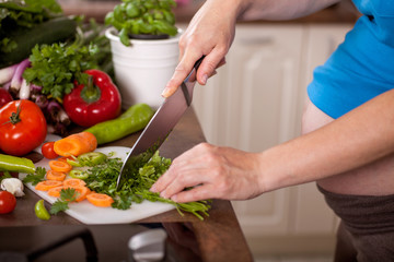 Pregnant Woman Chopping Up Fresh Vegetables