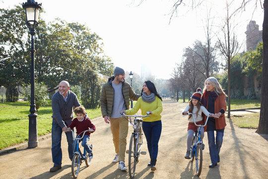 Multi generation family in park on with bicycles