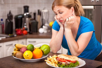 junk food or healthy food,concept of pregnant woman on a diet