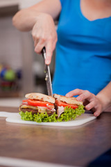 woman cuts home made burger