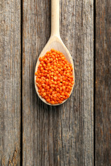Red lentils on a grey wooden table