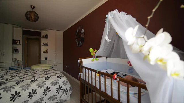New born child in wooden co-sleeper crib, Infant sleeping