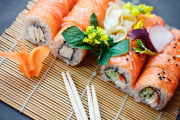 Sushi rolls Philadelphia with salmon and chopsticks in the restaurant
