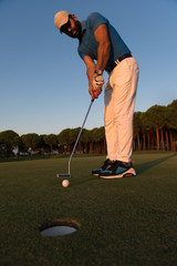 Fototapeta premium golfer hitting shot at golf course