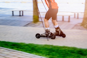 Man cross country skiing with roller ski