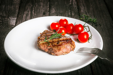steak and tomatoes on a plate