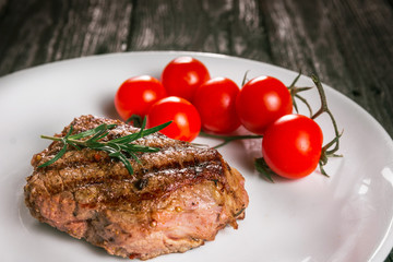 steak and tomatoes on a plate