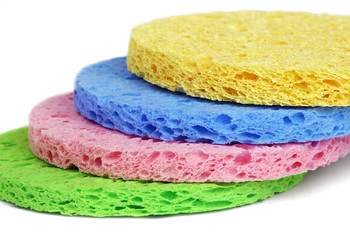 Some colorful  round facial cleansing sponges isolated on white background.