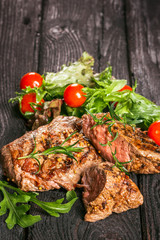 steak and salad on a wooden table