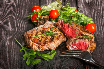 steak and salad on a wooden table