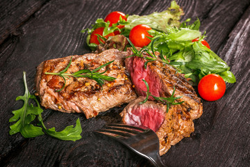 steak and salad on a wooden table