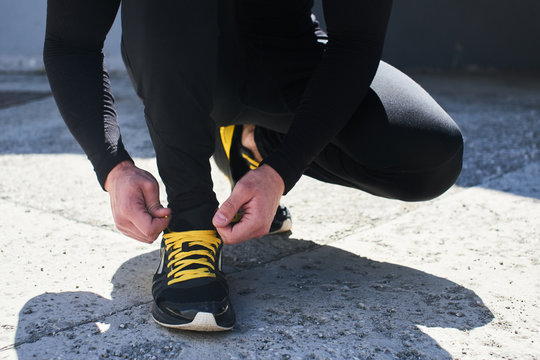 Mens hand tie the laces on sneakers