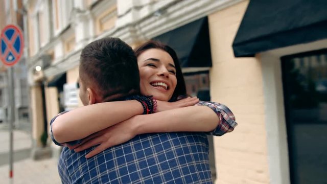 Happy couple hugging in the city, slow motion, shot at 60fps