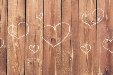 Drawn heart shapes on a wooden fence