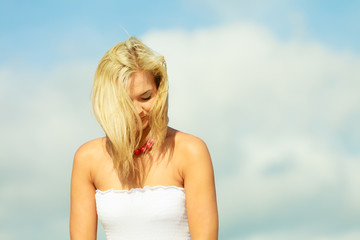 Fototapeta na wymiar Beauty blonde woman portrait on sky background.