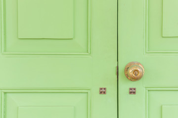 Vintage golden knob on the green door.