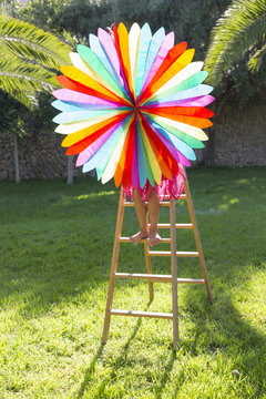 Girl putting up decoration in garden