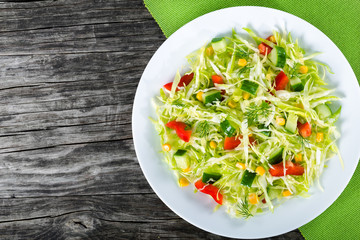 spring cabbige salad with bell pepper, corn, cucumber