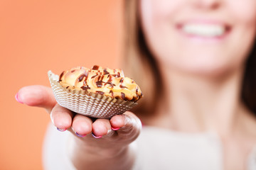 Delicious sweet cupcake in human hand. Gluttony