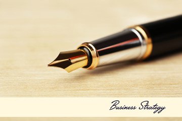 Fototapeta premium Fountain pen on wooden table background