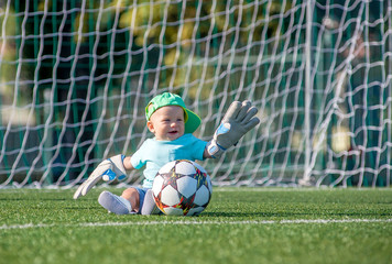 Kid with Ball on a football field