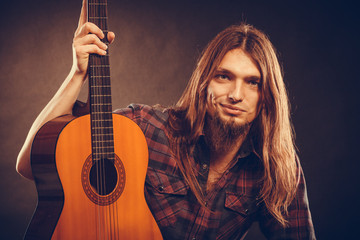 Young man holding guitar.