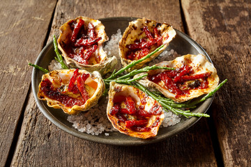 Plate of Oysters Kilpatrick on Rustic Wooden Table